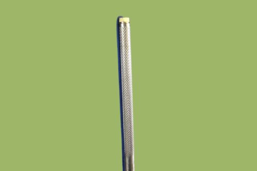 An Amish Stainless Steel Fishing Spear 7-tine on a green background.