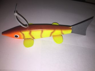 A toy fish with a yellow and black tail.