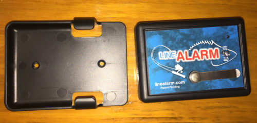 A black LineAlarm holder with the word Line Alarm on it.