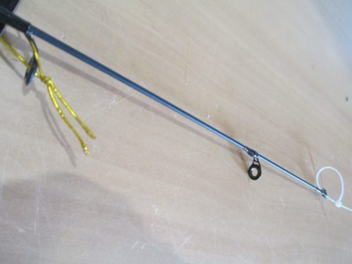 A HT Jig-A-Whopper 25" rod with a hook attached to it.