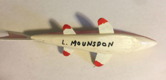 A 6-1/2 Inch Lamont Mounsdon Wood Spearing Decoys with the name l munson on it.