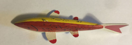 A 6-1/2 Inch Lamont Mounsdon Wood Spearing Decoys with red and yellow stripes.