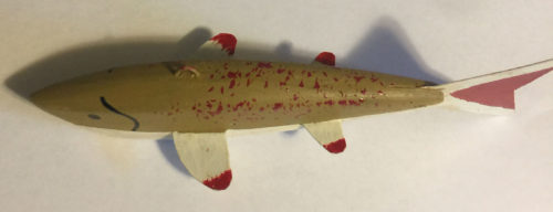 A 6-1/2 Inch Lamont Mounsdon Wood Spearing Decoys with red and white stripes.