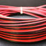 A 16 GAUGE 100 FT RED BLACK WIRE AWG laying on top of a black surface.