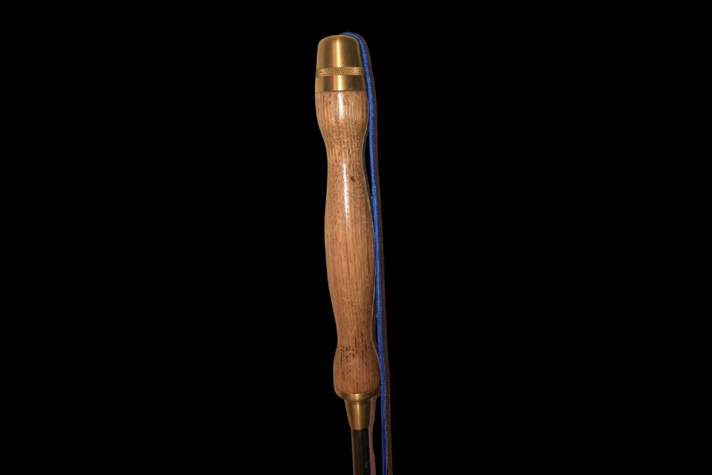A wooden tool with a brass handle on a black background called Amish Custom Made Wood Handled Stainless Steel Spear.