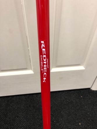 A red stick with the word Eskimo Economy Redneck Ice Chisel on it.