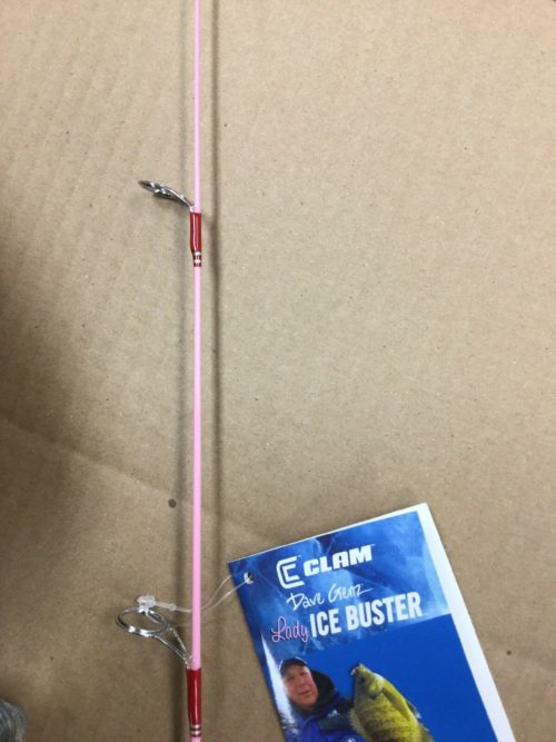 A Clam Lady Ice Buster Ice Fishing Combo 24" 9574 with a book on it.