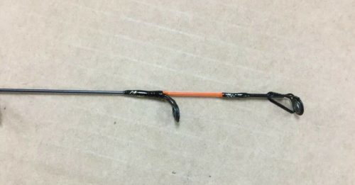 A Celsius Blizzard Ice Rod with an orange handle and a black handle.