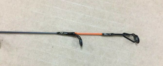 A Celsius Blizzard Ice Rod with an orange handle and a black handle.