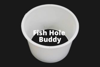A white cup with the words Fish Hole Buddy Ice Fishing Sleeves on it.