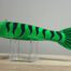 A Goodin Green Decoy, GDGT striped fish on a stand.