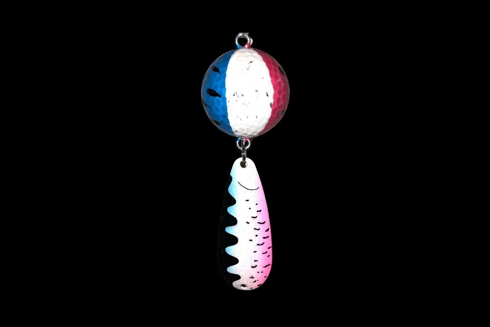 A NCS-003 Northern Crack Spearing Teaser Rainbow Trout (Wonder Bread) hanging on a black background.
