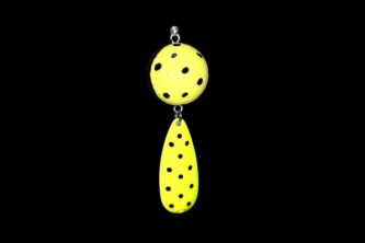 A NCS-028 Northern Crack Spearing Teaser Yellow with Black Dots hanging on a black background.