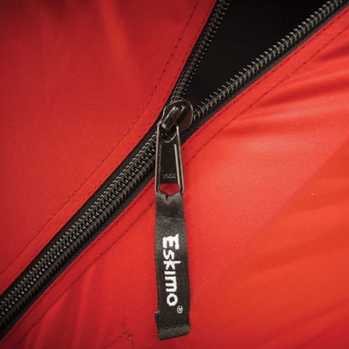 A close up of a Eskimo Fatfish 949i HUB Ice Shelter on a red jacket.