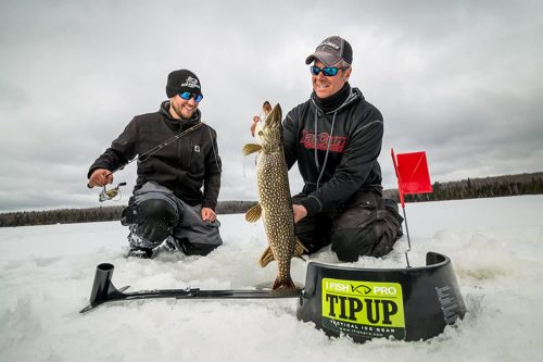 Two men holding up an I Fish Pro 2.0 Tip Up ifish pro in the snow.