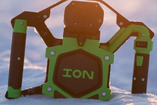 A green and black ION® ALPHA PLUS 8" or 10" 40 V Li Ion Ice Auger Poly sitting in the snow.
