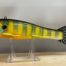 A yellow and blue plastic Goodin 9" frog decoy, orange on a stand.