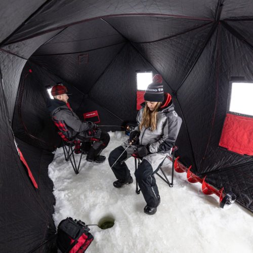 Two people sitting in chairs inside the Eskimo 36150 QuickFish 6i Pop-Up Portable Insulated Ice Fishing Shelter, 6 Person.