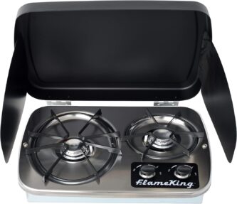 A Flame King 2 Burner Built-In RV Trailer Stove with Wind Shield with two burners and a lid.
