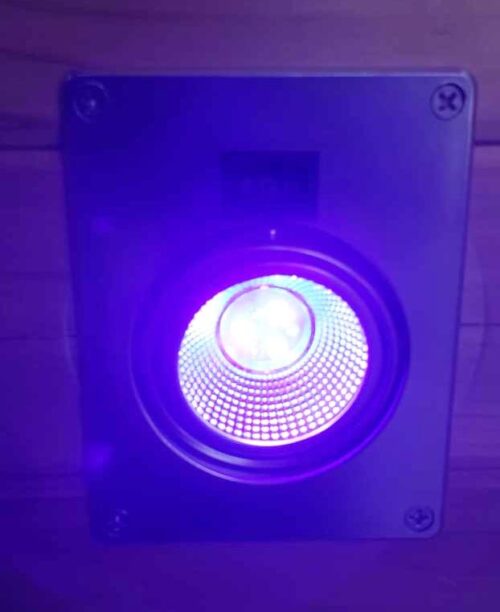 A Northern Lights Hole Light 12 VDC UV and White LED with Power Port in the ceiling of a room.